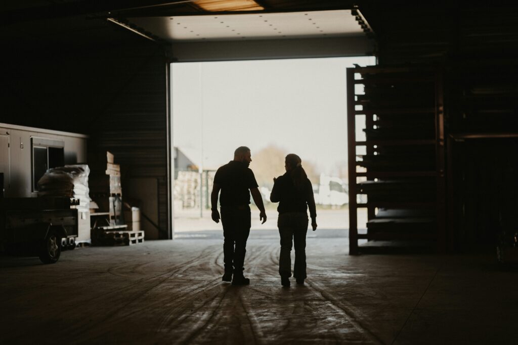 Two workers walking in a factory